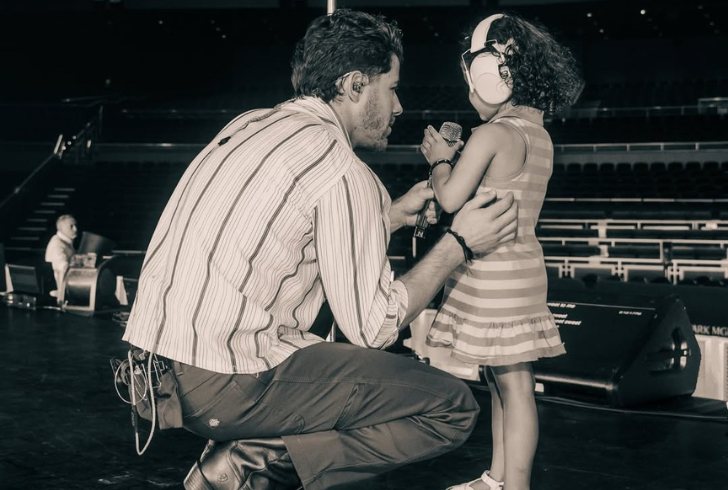 Father and daughter enjoying music together